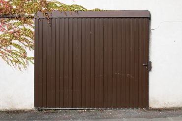 metallic brown garage door shutter curtain of facade closed car gate access